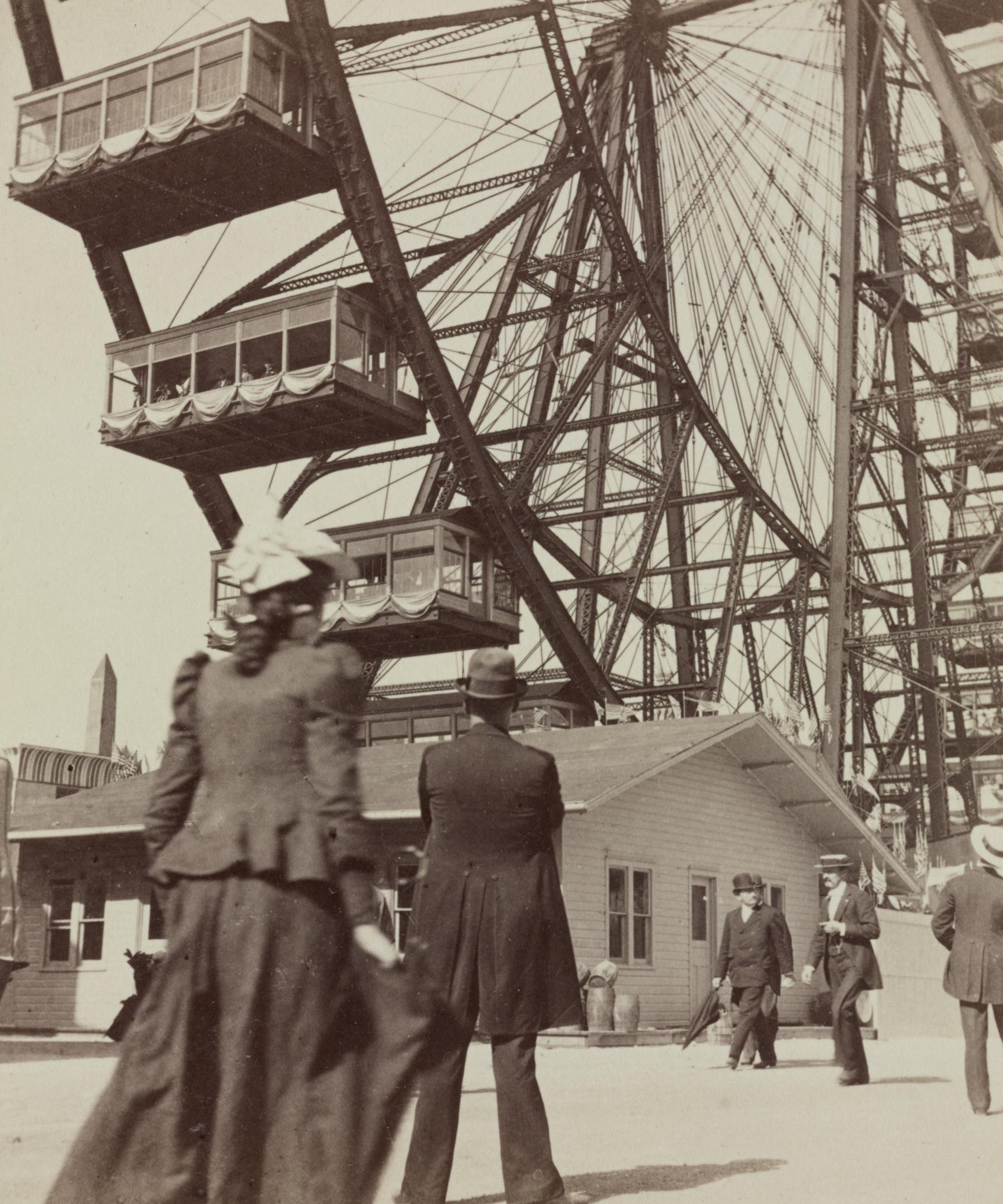 Passengers in large enclosed cars beside the steel structure of the original Ferris Wheel in Chicago